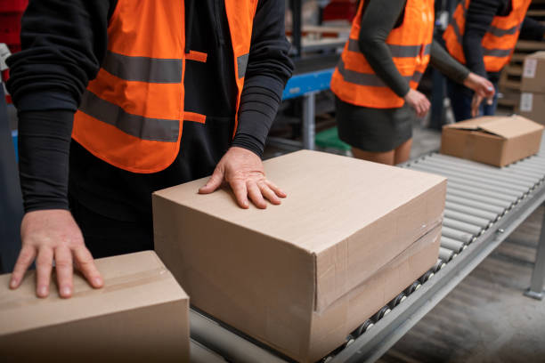 istock Three warehouse workers on a packing and delivery production line 1460478762
