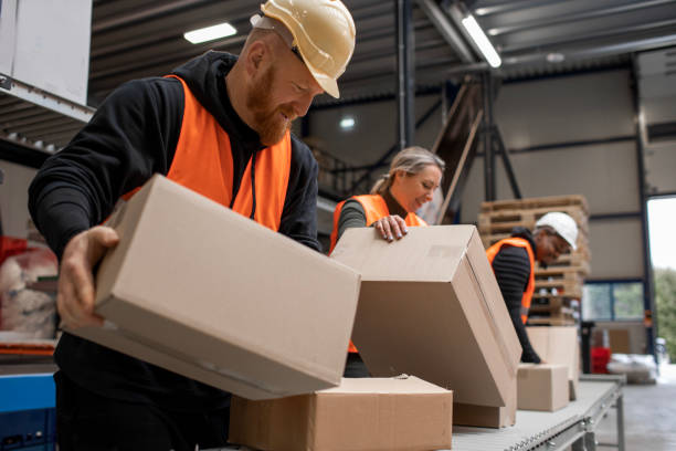 istock Three warehouse workers on a packing and delivery production line 1460478763