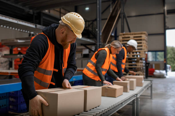 istock Three warehouse workers on a packing and delivery production line 1460478922