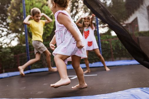 Beautiful siblings enjoying summer days. Fun on the trampoline.