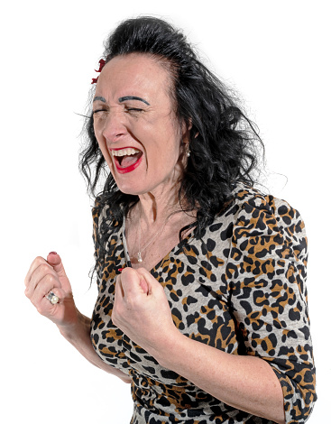 Angry woman in leopard dress screaming and clenching her fist