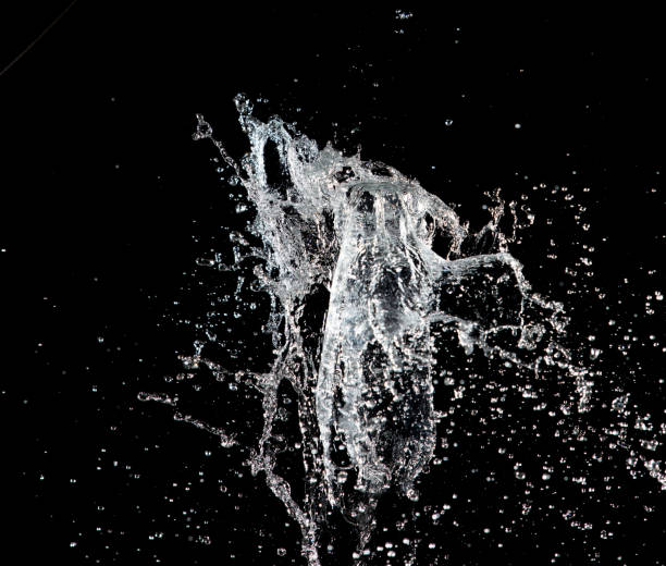 istock Water hit wall ground, explode into drop droplet. Amount Water attack impact and fluttering in air explosion. Stop motion freeze shot. Splash Water for texture elements, black background isolated 1460481173