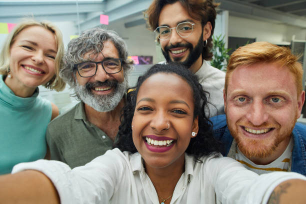 istock Colleagues looking at the camera taking selfie with cheerful expression. 1460481239