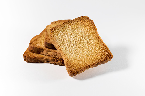 From above of delicious homemade fresh crispy bread rusks on white background