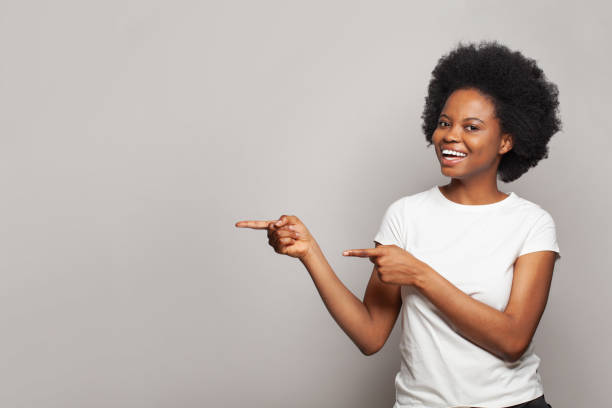 istock Joyful surprised woman pointing finger left copy space on white background 1460482881