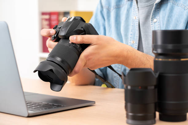 istock photographer man checking dslr camera 1460483953