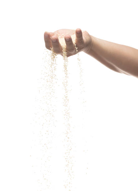 istock White Sesame pouring down from hand fingers, white Sesame grain wave floating, fall in air. Basil seed is organic healthy food. White background Isolated high speed shutter, freeze stop motion 1460484902