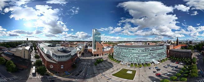 Västerås, Västmanland, Sweden - 09.02.2022: Aerial drone image over one of the most iconic buildings in Vasteras, Hotel Plaza. Modern architecture in the city center. Glass facade and cloud reflections. One of the most recognizable buildings in the city. Summer, daytime image.