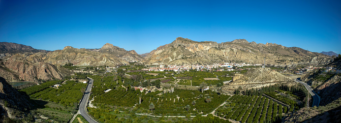 Panoramic view of part of the Ricote Valley with its orchard, the mountains and the town of Ulea in the background