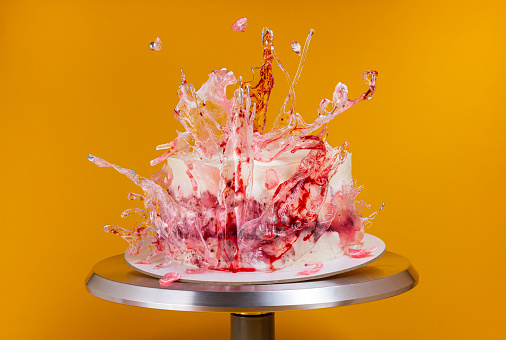 istock Contemporary Cake decorated transparent with silver drops red caramel on bright yellow background 1460486913