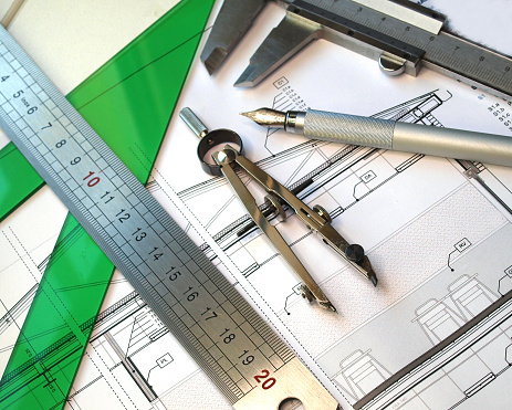 architect drafting tools displayed over detail blueprint