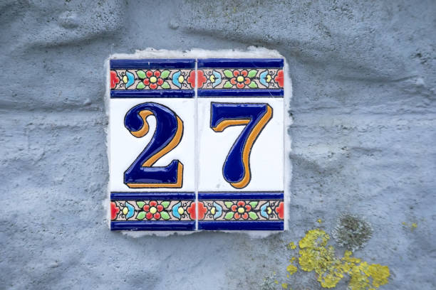 istock A number on a gray cement wall with blue and orange patterns 1460489498