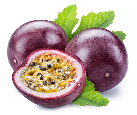 Purple passion fruits with leaves and half of fruit with yellow seedy flesh. Isolated on white background.