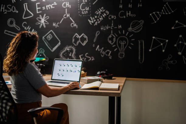 istock Chemistry teacher sitting at her desk and planning her classes for students 1460496885