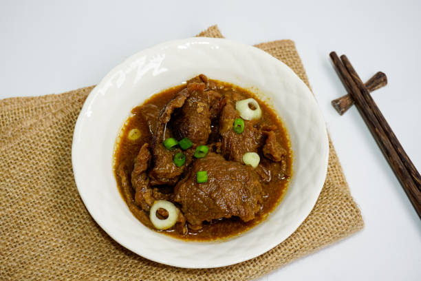 istock Beef teriyaki served with fresh leek and onion sliced in white plate isolated on white background. Selective focus. 1460498241