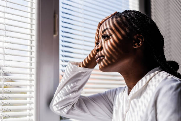 istock Overworked doctor taking a break from work by the window, looking outside, contemplating 1460498285