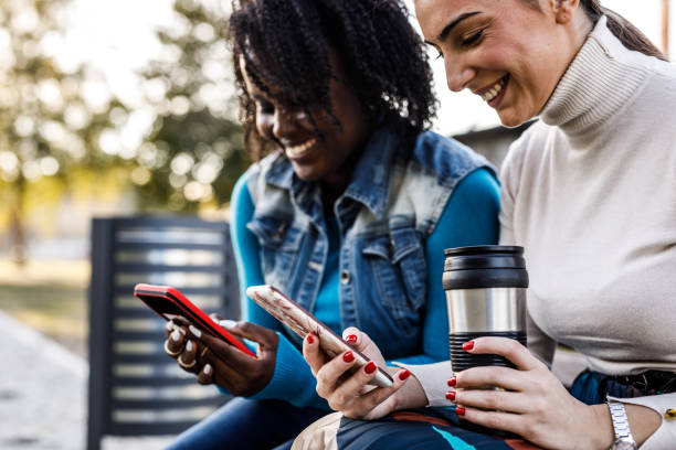 istock Girlfriends having coffee and using their smart phones when hanging out 1460501195