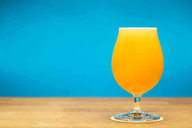 istock Full tulip glass of NEIPA beer on a table 1460506018