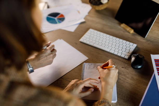 istock Two young businesswomen reviewing documents when having a project meeting 1460506534