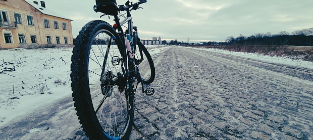Bicycle ride on icy cobblestone road
