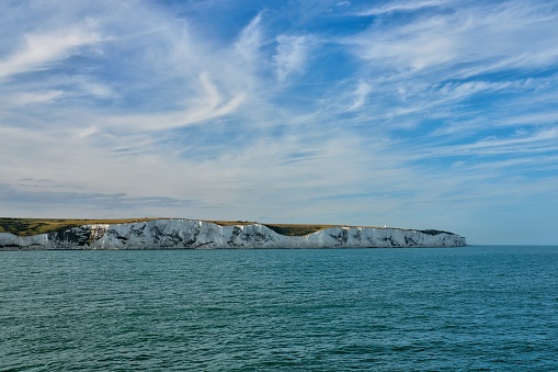 Sea view of the famous white cliffs near Dover in UK from a ferry leaving France toward Great Britain.
