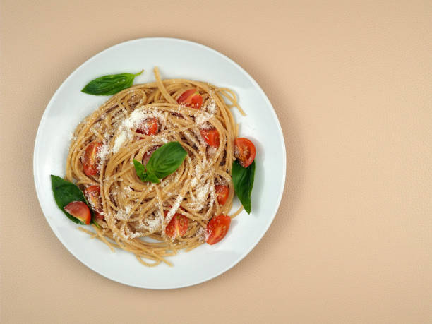 istock Whole grain spaghetti pasta with cherry tomatoes, basil and parmesan cheese. 1460509831