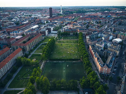Aerial drone shot of  a public park featuring and playground in at Nørrebro in Copenhagen, Denmark.