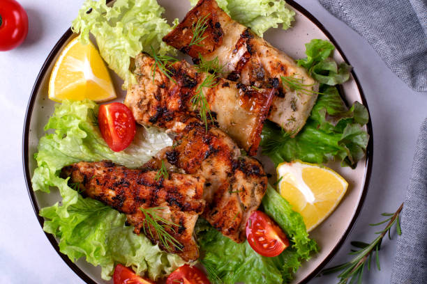 istock Grilled sturgeon pieces served with fresh salad 1460514425