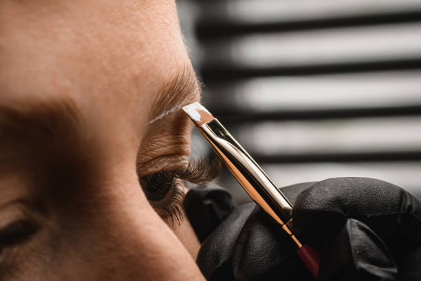 istock close-up on brush with white paste which makeup artist makes markings for eyebrow correction 1460517429