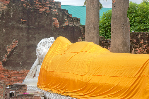 Reclining Buddha statue in Wat Yai Chai Mongkol temple. Ayutthaya Historical Park, Thailand. UNESCO World Heritage Site.