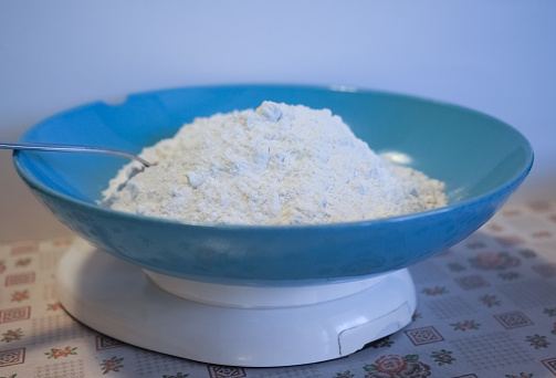 flour in a dish on a kitchen scale