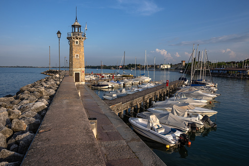 Lighthouse at the harbor in Desenzano del Garda , lake Garda, Italy