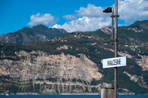 Malcesini ferry port sign on the eastern shore of lake Garda in northern Italy.