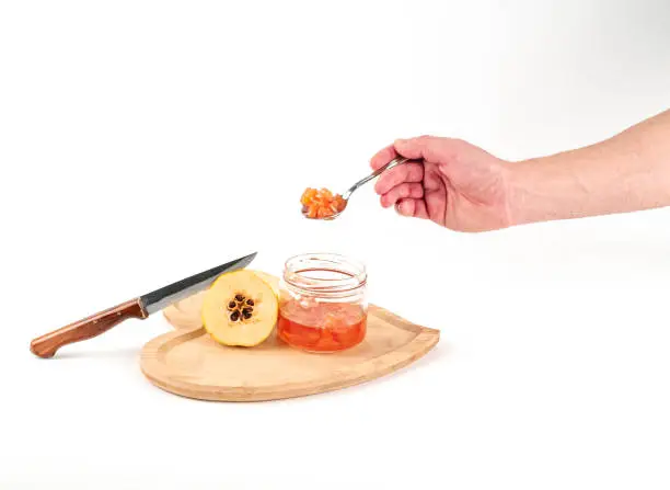 Photo of Fresh ripe quince and jam on white background isolated.