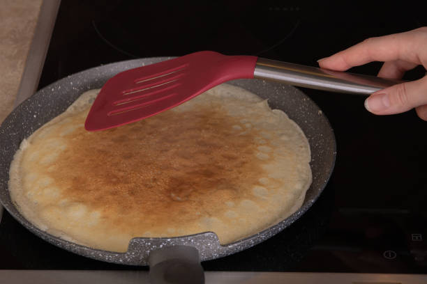 istock photo of a fried thin pancake on a pan 1460524276