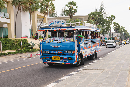 Songthaew - local open-air bus. Open blue bus on the route between the beaches of Phuket Karon and Kata. Phuket, Thailand - 24.01.2023