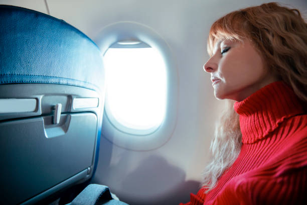 istock Woman sleeping in plane 1460528616