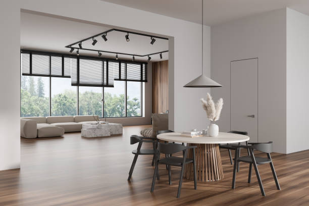 istock Light living room interior with eating table and couch, panoramic window 1460530527