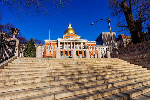 Boston, Massachusetts, USA - January 27, 2023: Massachusetts State House, view up the steps of the Boston Common. The State House is the state capitol and seat of government for the Commonwealth of Massachusetts.