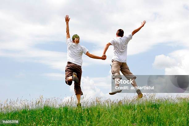 Feliz Pareja Joven Saltar Foto de stock y más banco de imágenes de Actividad - Actividad, Actividades recreativas, Adolescencia