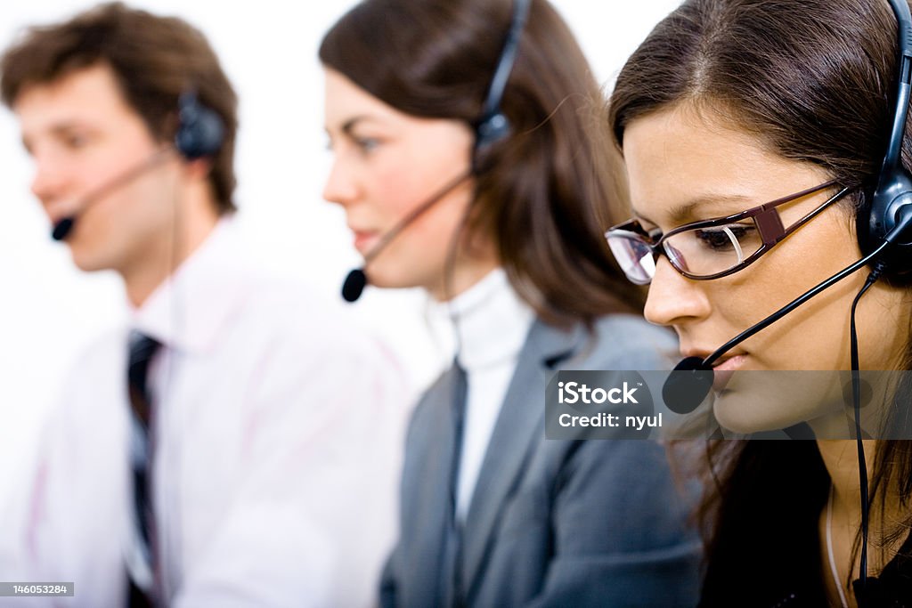 Customer Service Team Customer service team working in headsets, woman in front. 20-24 Years Stock Photo