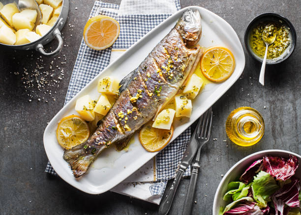 istock Roasted trout fish with potato and salad 1460533486