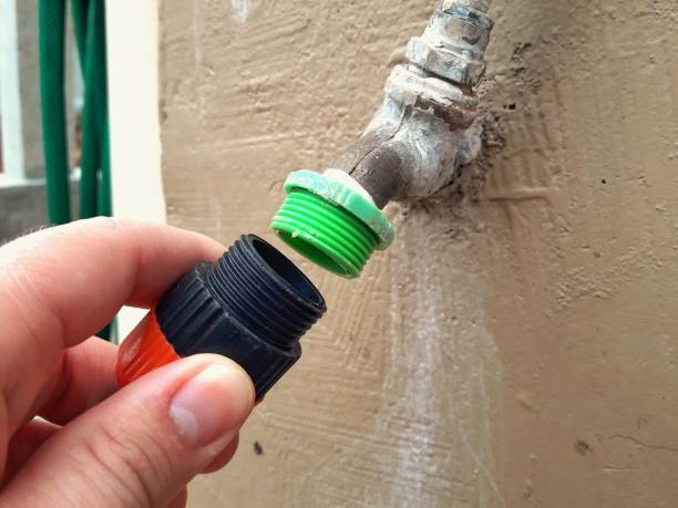 istock Attaching a hose to a faucet. 1460537205