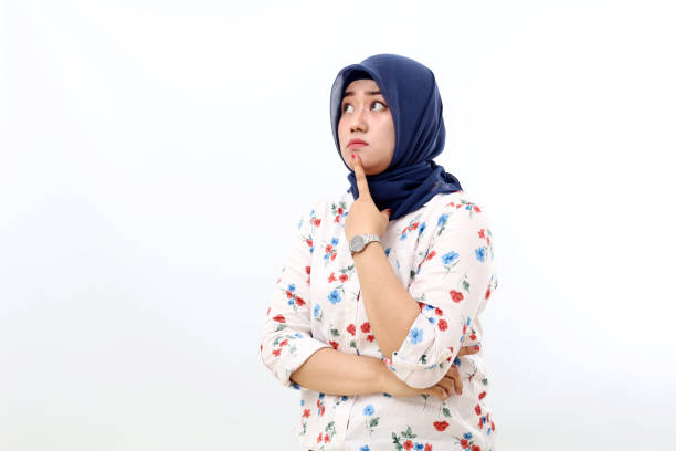 istock Thoughtful asian muslim woman standing while thinking and imaging something. Isolated on white 1460537709
