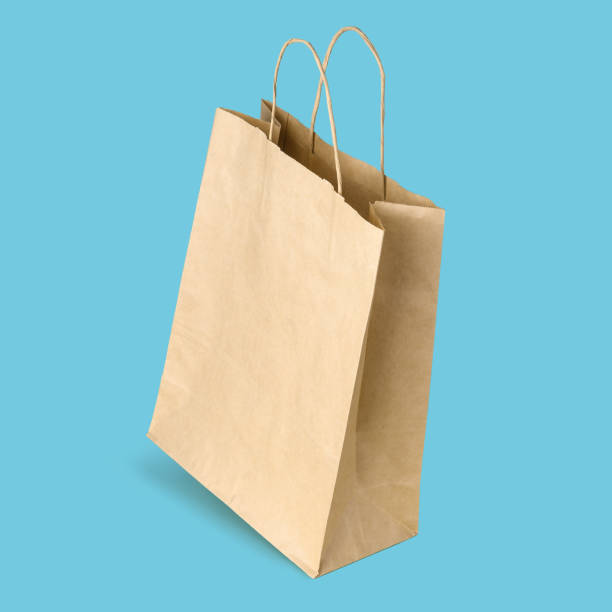 istock Blank shopping paper bag isolated on blue background 1460537761
