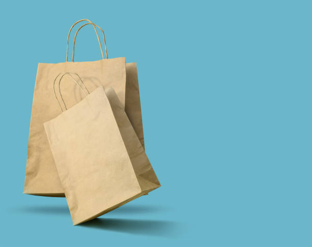 istock Brown paper bags on blue background. Copy space 1460537770