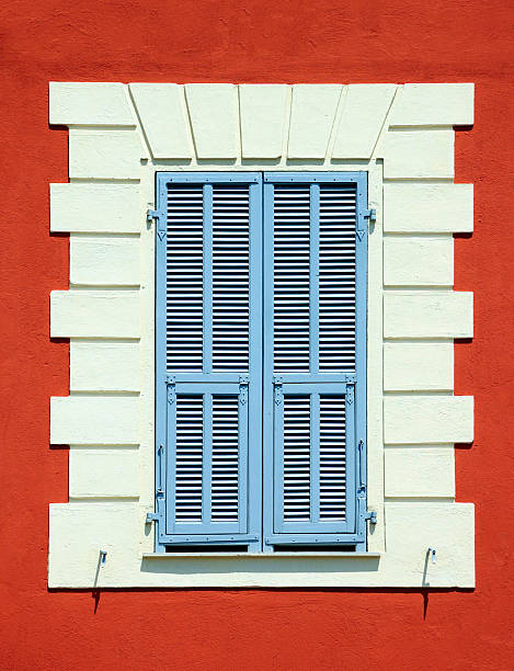 Mediterranean colourful window with blue shutters stock photo