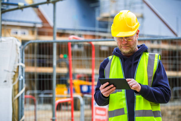Construction worker using digital tablet on building site stock photo