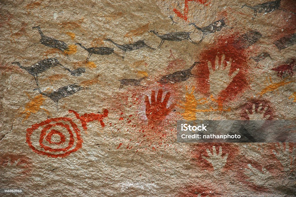 Ancient Cave Painting Ancient cave art of Patagonia, depicting herd of animals, hand paintings, and a spiral. Cave Painting Stock Photo