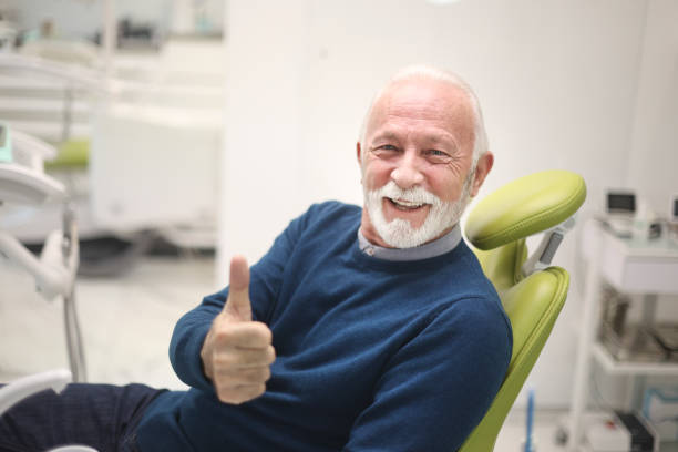 istock Smiling senior man at a dentist's office 1460541287